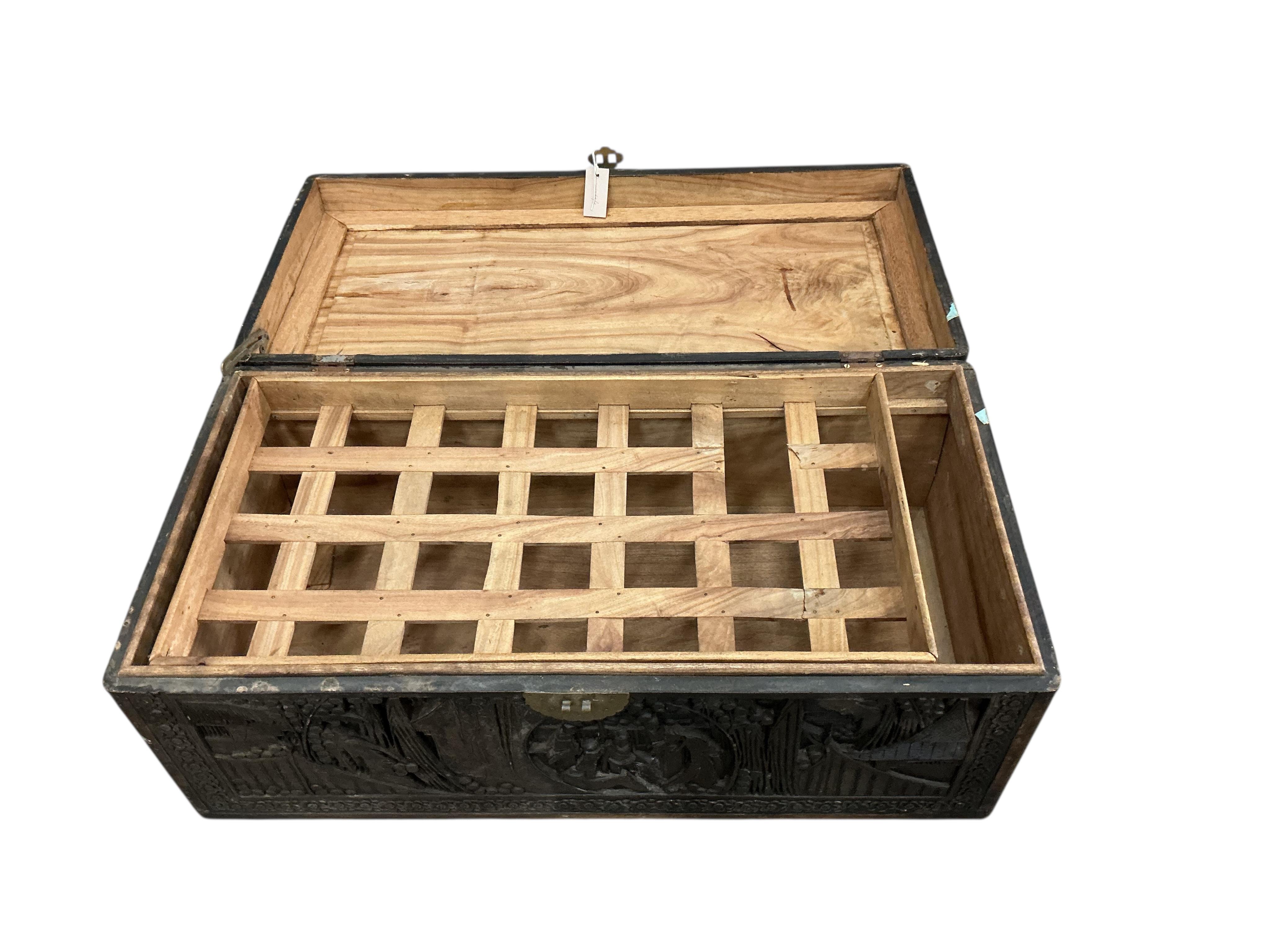 A Chinese carved camphor wood trunk, width 90cm, depth 44cm, height 36cm